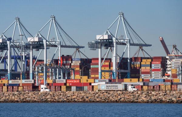 Trucks loaded with shipping containers prepare to leave the Port of Long Beach, Calif., on Oct 27, 2021. (John Fredricks/The Epoch Times)