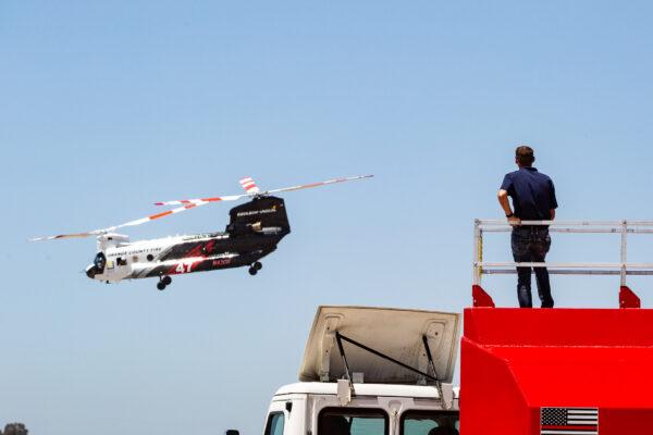 Orange County Fire Authority and partners Ventura and Los Angeles County fire departments gather for the release of a new Cu-47 Helitanker twin rotor helecopter capable of releasing 3000 gallons on fire retardent upon wildfires. Los Alamitos, Calif., on June 14, 2021. (John Fredricks/The Epoch Times)