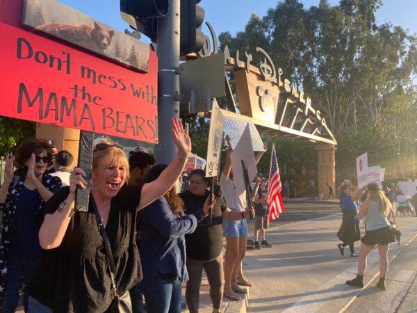 Protestors rally in opposition to The Walt Disney Company's stance against a recently passed Florida law outside of the company's headquarters in Burbank, Calif., on April 6, 2022. (Jill McLaughlin/The Epoch Times)