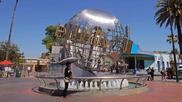 Toursits get their picture taken at the front entrance of Universal Studios Hollywood theme park in Universal City, Calif,. on May 4, 2010. (Kevork Djansezian/Getty Images)