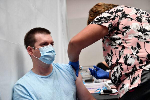 A nurse practitioner administers a dose of the Moderna Covid-19 vaccine at a clinic for Catholic school education workers including elementary school teachers and staff at a vaccination site at Loyola Marymount University in Los Angeles on March 8, 2021. (Patrick T. Fallon/AFP via Getty Images)