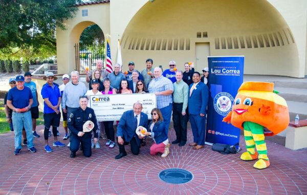 Rep. Lou Correa (D-Calif.) presents a check for $2 million for the construction of pickleball courts at Hart Park in Orange, Calif., on April 21, 2022. (John Fredricks/The Epoch Times)