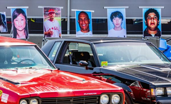 Posters of street racing offenders and victims sit on display next to racecars in Santa Ana, Calif., on April 29, 2022. (John Fredricks/The Epoch Times)