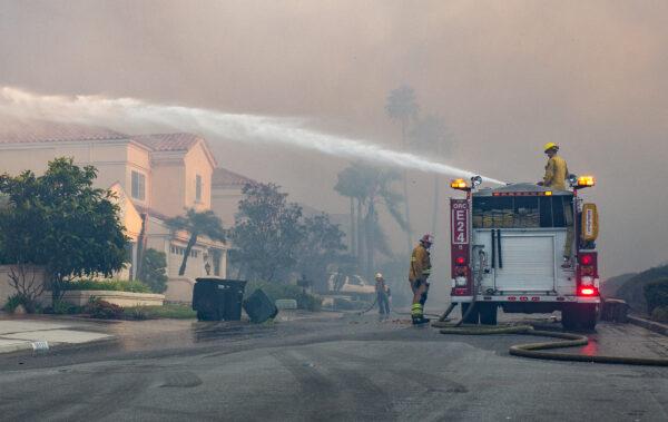 Firefighters work on extinguishing the Coastal Fire in Laguna Niguel, Calif., on May 11, 2022. (John Fredricks/The Epoch Times)