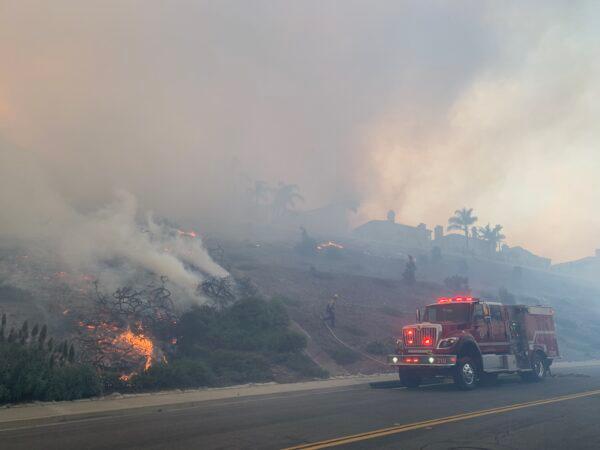 A fire chews through brush in Aliso Wood Canyon between Laguna Niguel and Laguna Beach, Calif., on May 11, 2022. (John Fredricks/The Epoch Times)