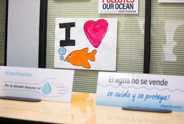 Signs protesting the Huntington Beach desalination plant sit on display in Costa Mesa, Calif., on May 11, 2022. (John Fredricks/The Epoch Times)