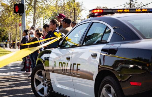 Parents and family members wait for students on lockdown at Santa Ana High School after bomb and weapon threats circulated at the school in Santa Ana, Calif., on March 10, 2022. (John Fredricks/The Epoch Times)