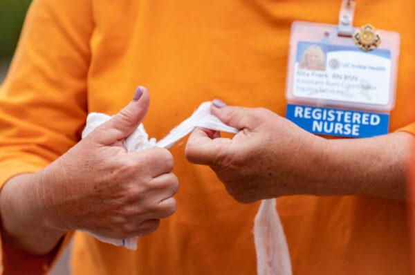 A nurse wraps a bandage after demonstrating the treatment of a mock gun wound at UCI Medical Center in Orange, Calif., on June 3, 2022. (John Fredricks/The Epoch Times)