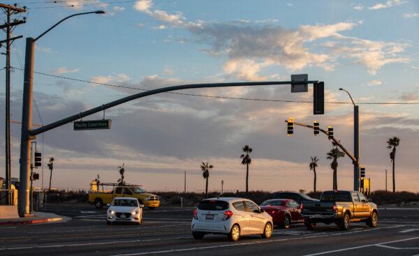 Cars drive along Pacific Coast Highway in Huntington Beach, Calif., on Nov. 12, 2020. (John Fredricks/The Epoch Times)