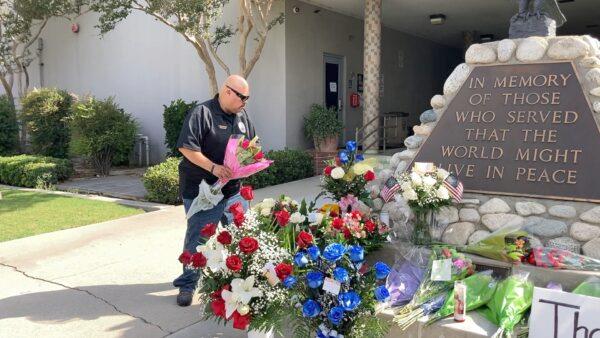 Local officials and community members mourn the two El Monte officers killed in the line of duty at a June 14 motel shooting in front of the El Monte Police Department on June 15, 2022. (Annie Wang/NTD Television)