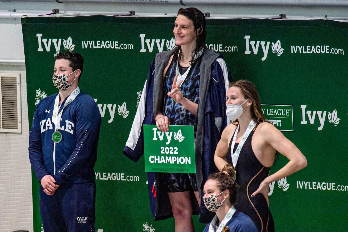 Pennsylvania State University swimmer Lia Thomas (2nd L)—a male who identifies as female—and  Yale swimmer Iszac Henig (L)—a female who identifies as male—pose with their medals after placing first and second in the 100-yard freestyle swimming race at the 2022 Ivy League Women's Swimming & Diving Championships at Harvard University in Cambridge, Mass., on Feb. 19, 2022. (Joseph Prezioso/Getty Images)