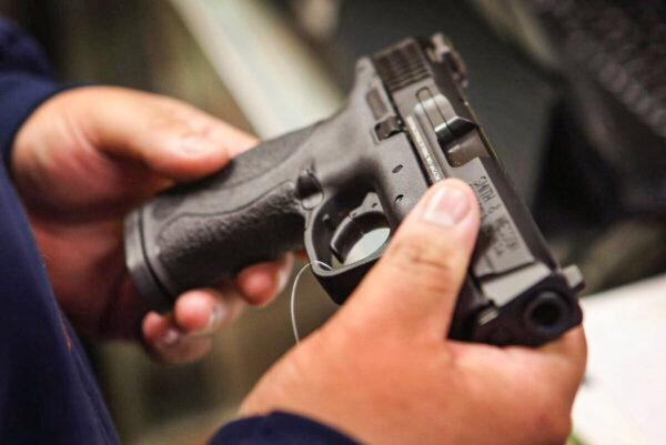 A customer shops for a pistol in Tinley Park, Ill., on Dec. 17, 2012. LAPD detectives said they recovered two semiautomatic pistols connected to follow-away robberies. (Scott Olson/Getty Images)