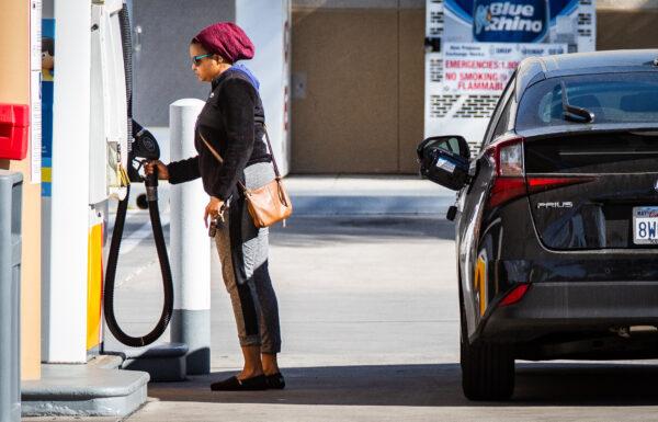 A driver fills her car with gas amid record-high fuel prices, in Irvine, Calif., on Feb. 23, 2022. (John Fredricks/The Epoch Times)