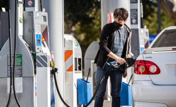 Gas stations serve customers at peak prices in Irvine, Calif., on Feb. 23, 2022. (John Fredricks/The Epoch Times)