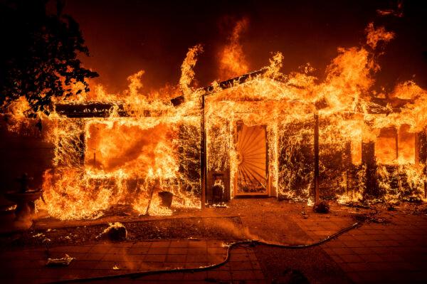 Flames consume a home on Triangle Road as the Oak Fire burns in Mariposa County, Calif., on July 23, 2022. (Noah Berger/AP Photo)