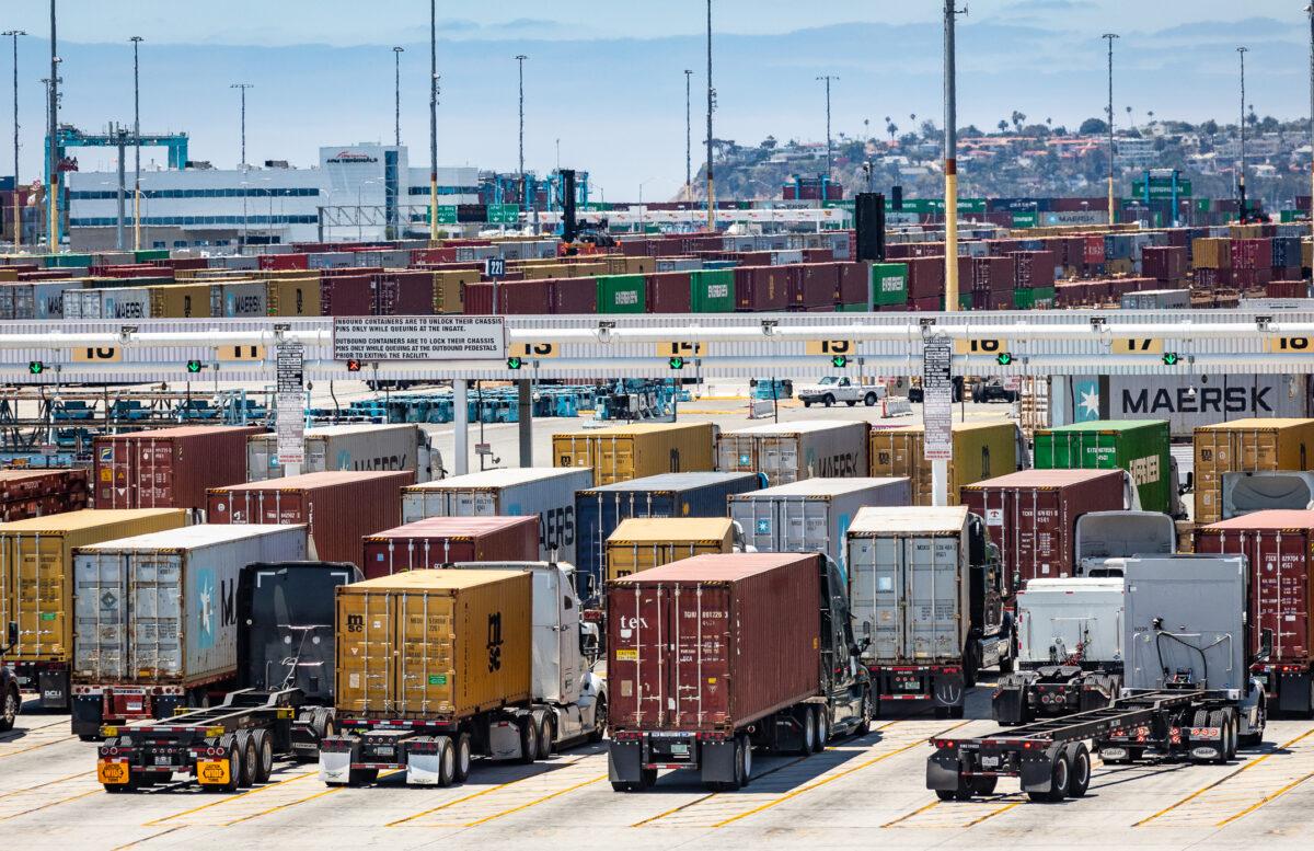 Truckers move shipping containers out of the Port of Long Beach, Calif., on July 13, 2022. (John Fredricks/The Epoch Times)