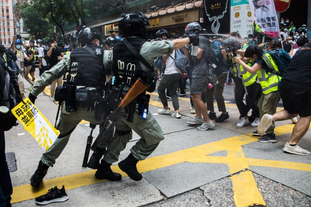 Riot police pepper spray journalists on the 23rd anniversary of the city's handover from Britain to China as protesters gathered for a rally against the new National Security Law in Hong Kong on July 1, 2020. (Dale De La Rey/AFP via Getty Images)