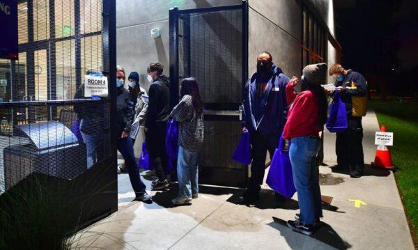 Volunteers wait in line to register before heading into the first night of the Greater Los Angeles Homeless Count in Covina, Calif., on Feb. 22, 2022. (Frederic J. Brown/AFP via Getty Images)