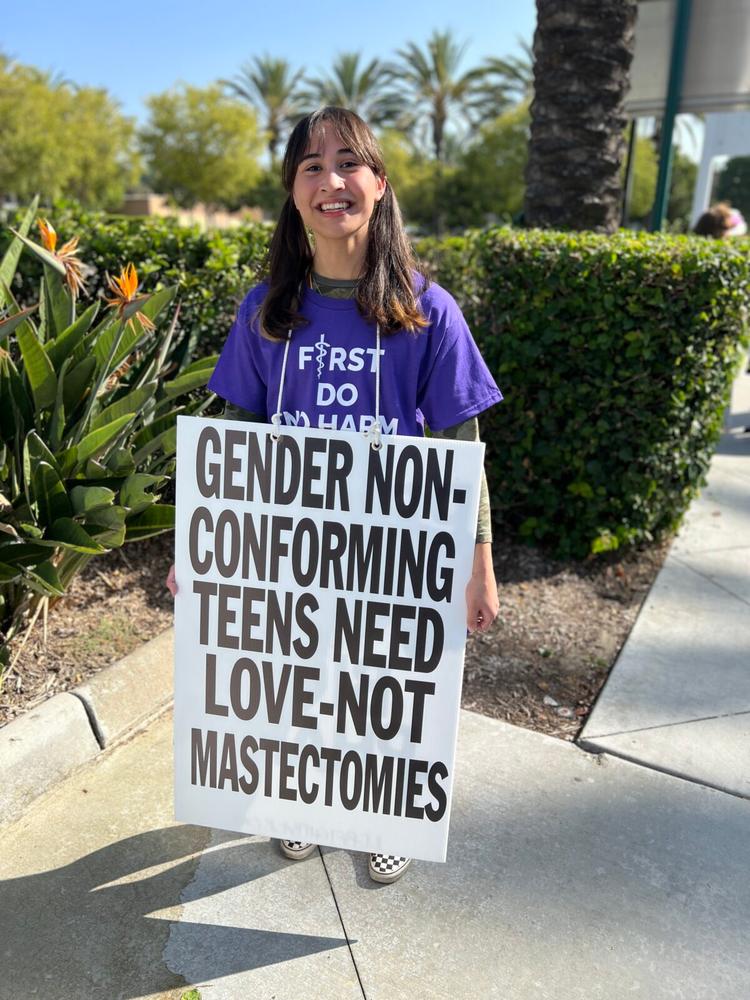 Chloe Cole takes part in a demonstration in Anaheim, Calif., on Oct. 8, 2022. (Brad Jones/The Epoch Times)