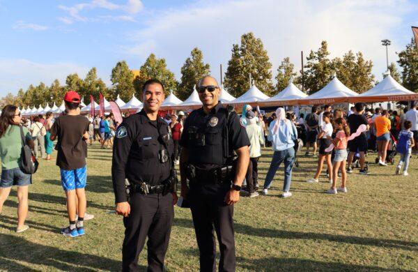 Irvine Police officers on duty in the dining area during the 21st Irvine Global Village Festival on Oct. 8, 2022. (Mei Li/ The Epoch Times)