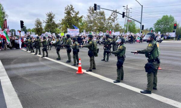 Orange County Sheriff's deputies line up in front of protesters at Irvine Valley College during President Joe Biden's speech there in Irvine, Calif., on Oct. 14, 2022. (Rudy Blalock/The Epoch Times)