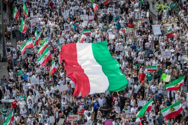 Demonstrators hold Iran's flag during a protest for Mahsa Amini who died in custody of Iran's morality police, in Los Angeles on Oct. 1, 2022. (Apu Gomes/AFP via Getty Images)