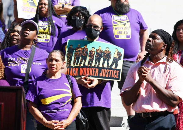 SEIU California union members stand at a demonstration outside City Hall calling for the resignations of L.A. City Council members Kevin de Leon and Gil Cedillo in the wake of a leaked audio recording in Los Angeles, Calif., on Oct. 18, 2022. (Mario Tama/Getty Images)