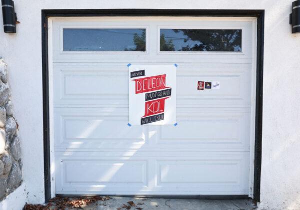 A sign calling for the resignation of L.A. City Council member Kevin de Leon is posted on the garage of de Leon's home in the wake of a leaked audio recording in Los Angeles, Calif., on Oct. 18, 2022. (Mario Tama/Getty Images)