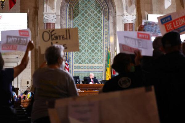 New LA City Council President Paul Krekorian (C) presides near protestors as the council holds its first in-person meeting since he became president in the wake of a leaked audio recording in Los Angeles, Calif., on Oct. 25, 2022. (Mario Tama/Getty Images)