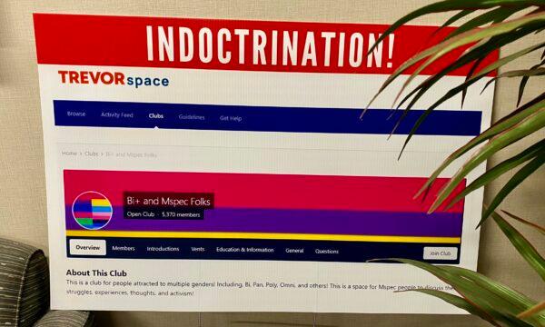 Parents and community members bring signs displaying TrevorSpace youth chatrooms with controversial topics at an Orange County Board of Education meeting in Costa Mesa, Calif., on Nov. 2, 2022. (Micaela Ricaforte/The Epoch Times)