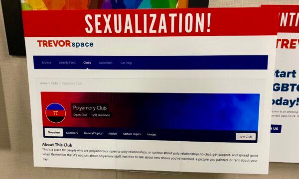 Parents and community members bring signs displaying TrevorSpace youth chatrooms with controversial topics at an Orange County Board of Education meeting in Costa Mesa, Calif., on Nov. 2, 2022. (Micaela Ricaforte/The Epoch Times)