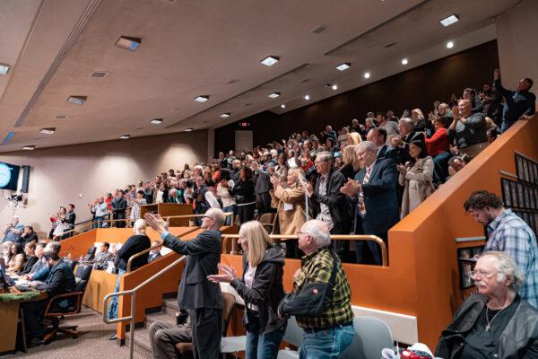 The crowd gives a standing ovations during the council meeting in Huntington Beach, Calif., on Dec. 6, 2022. (Julianne Foster/The Epoch Times)