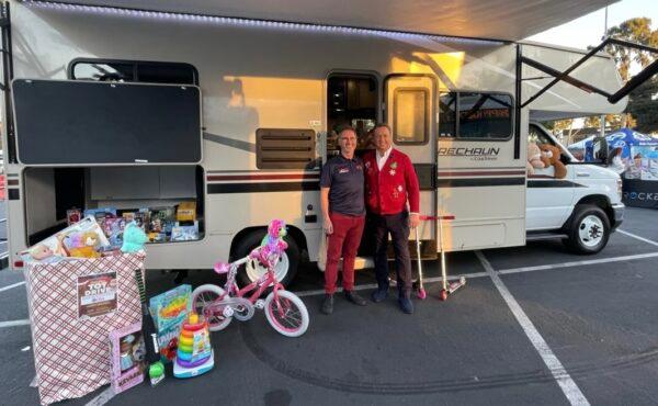 George Pennacchio (L) of KABC and Tom Wigginton (R) of El Monte RV are seen at the KABC's Stuff-a-Bus in Cerritos, Calif., on Dec. 9, 2022. (Courtesy of El Monte RV)
