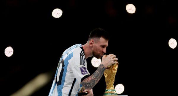 Argentina's Lionel Messi celebrates with the trophy after winning the World Cup during the match of Argentina vs. France in Lusail Stadium in Lusail, Qatar, on Dec. 18, 2022. (Reuters/Lee Smith)