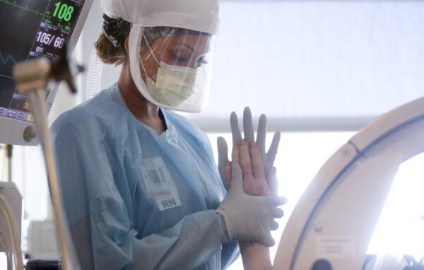 A nurse performs range of motion exercises on a COVID-19 patient in the Intensive Care Unit at Sharp Grossmont Hospital amidst the coronavirus pandemic in La Mesa, Calif., on May 5, 2020. (Mario Tama/Getty Images)