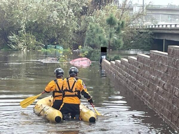 A swift water rescue team rescues a woman whose car was submerged in the San Diego River in Mission Valley, Calif., on Jan. 16, 2023. (Courtesy of the San Diego Fire Department)