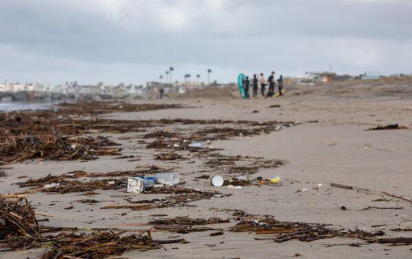 Debris is seen on the beach in Newport Beach, Calif., after a rainstorm on Jan. 16, 2023. (John Fredricks/The Epoch Times)
