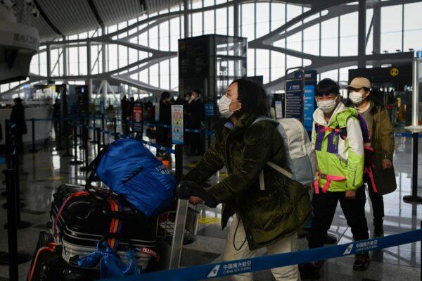 Passengers prepare to check in at Daxing International Airport in Beijing on Jan. 19, 2023. (Wang Zhao/AFP via Getty Images)