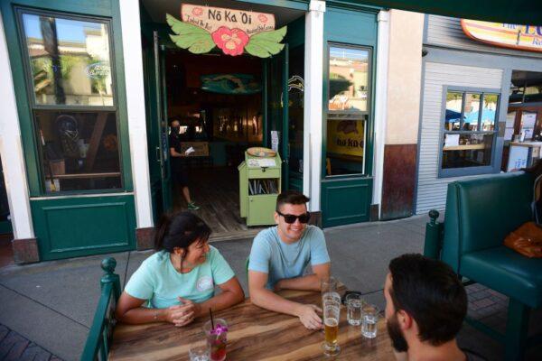 People enjoy outdoor drinks and dining on Main Street in Huntington Beach, Calif., on July 16, 2020. (Robyn Beck/AFP via Getty Images)