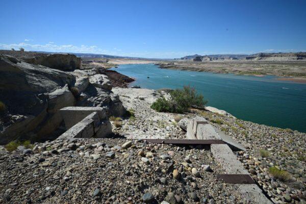 Discarded structures where water used to reach are seen as people enjoy the water of the Colorado River in Lake Powell, despite lower than normal water levels, in Wahweap Bay in Page, Ariz., on Sept. 3, 2022. (Robyn Beck/AFP via Getty Images)