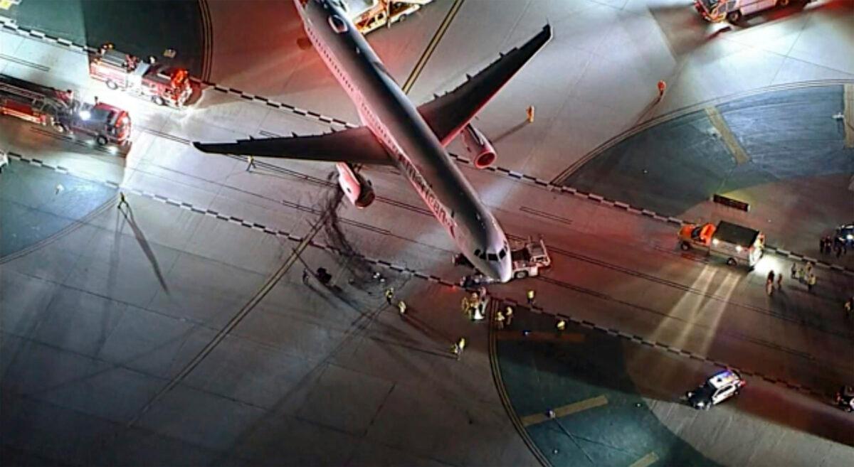 An American Airlines aircraft is damaged after a collision with a passenger bus at Los Angeles International Airport in Los Angeles early on Feb. 11, 2023. (KABC via AP)