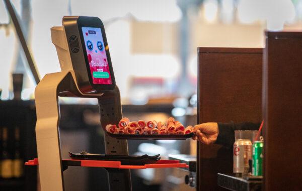 A robot delivers food orders at I Can Korean Barbecue in Tustin, Calif., on Feb. 14, 2023. (John Fredricks/The Epoch Times)