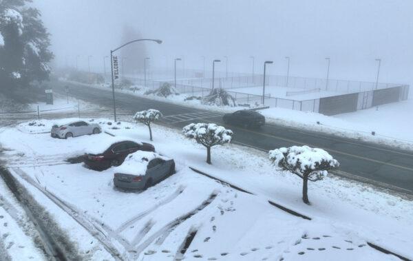 In an aerial view, cars are seen covered in snow at Pacific Union College in Angwin, Calif., on February 24, 2023. (Justin Sullivan/Getty Images)