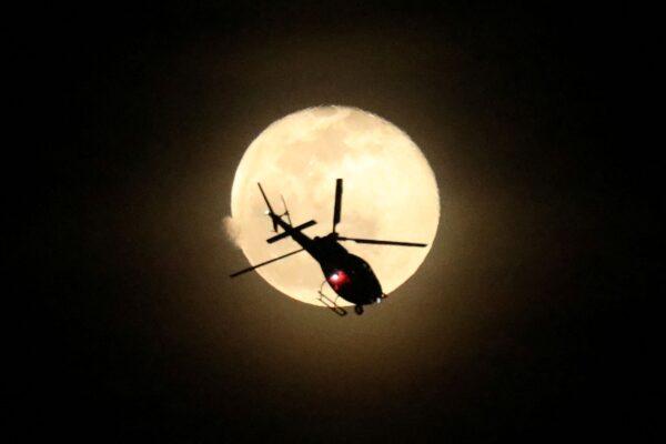 An LAPD helicopter circles the Lincoln Park neighborhood after it was cordoned off as police look for a gunman who shot three police officers, in Los Angeles, Calif., on March 8, 2023. (David Swanson/Reuters)