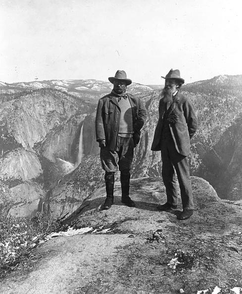 President Theodore Roosevelt (L) poses with naturalist and botanist John Muir on Glacier Point in Yosemite, California. The original Yosemite National Park firefall started here in 1873. (MPI/Getty Images)