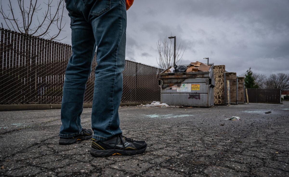 Brett Boman looks at a dumpster he used to eat out of while homeless and on drugs in Chico, Calif., on March 12, 2023. (John Fredricks/The Epoch Times)