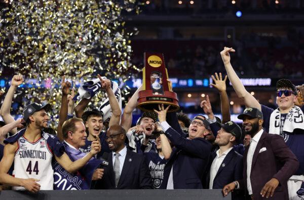 Coach Dan Hurley of Connecticut holds up the championship trophy after the Huskies defeated San Diego State in the NCAA championship game in Houston on April 3, 2023. (Gregory Shamus/Getty Images)