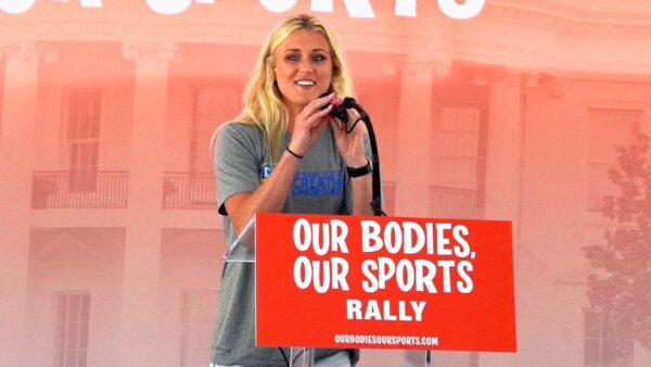 Riley Gaines Barker, a former University of Kentucky swimmer who tied for fifth place against transgender swimmer Lia Thomas at the NCAA Championships in March, speaks at the “Our Bodies, Our Sports” rally at Freedom Plaza in Washington on June 23, 2022. (Terri Wu/The Epoch Times)