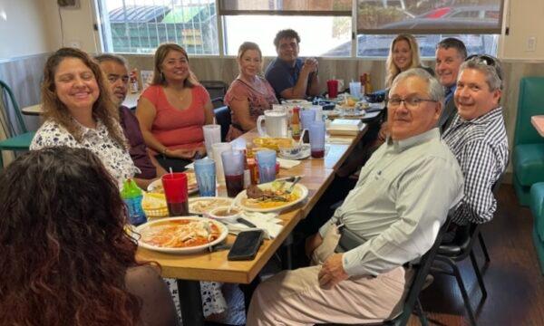 Ron Flores (front R), president of ¡BASTA!—a voter nonprofit based in Santa Ana, Calif., with a mission to register minority voters—attends a business lunch gathering. (Courtesy of Ron Flores)
