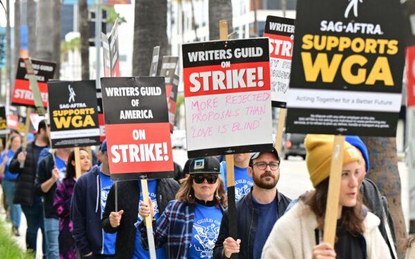Writers on strike march with signs on the picket line on day four of the Writers Guild of America strike in front of Netflix in Hollywood, Calif., on May 5, 2023. (Frederic J. Brown/AFP via Getty Images)